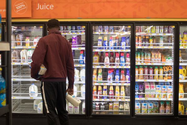 10/10/2018 -- Albany, Georgia -- A man peruses the remnants of the milk and juice aisle while shopping at Wal-Mart in Albany, Wednesday, October 10, 2018. Bread, water and non-perishable snacks were diminished around noon at the Albany supermarket. Hurricane Michael has been upgraded to a Category 4 storm. (Alyssa Pointer/AJC.COM)