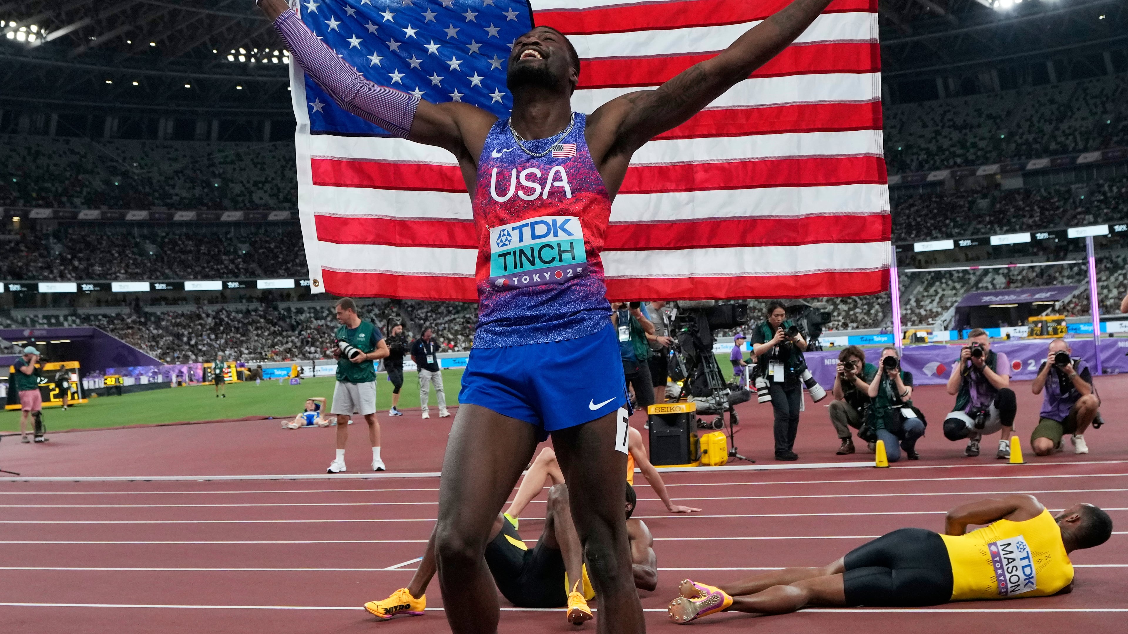 United States' Cordell Tinch celebrates after winning gold medal in men's 110 meters hurdles final at the World Athletics Championships in Tokyo, Tuesday, Sept. 16, 2025. (AP Photo/Eugene Hoshiko)