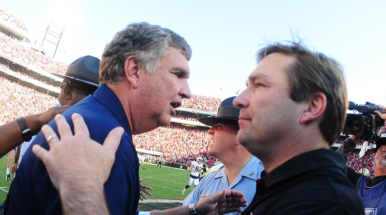 ATHENS, GA - NOVEMBER 26: Head Coach Paul Johnson (L) of the Georgia Tech Yellow Jackets is congratulated after the game by Head Coach Kirby Smart of the Georgia Bulldogs at Sanford Stadium on November 26, 2016 in Athens, Georgia. (Photo by Scott Cunningham/Getty Images)