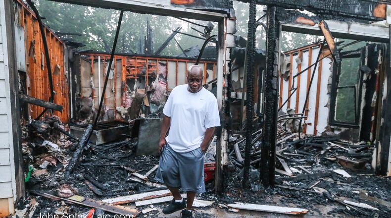 Bill Thomas walked through his mother’s burned home after a fire in DeKalb County. JOHN SPINK / JSPINK@AJC.COM