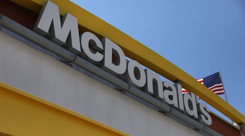 Two Memphis policemen attempting to make an arrest were hit by a car in a McDonald's parking lot Friday.
