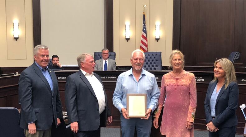 Alpharetta recently recognized long-time resident Larry Attig for his years of service on the Planning Commission with a service award and proclamation. Shown here with his wife, Margo, and city leaders. (Courtesy City of Alpharetta)