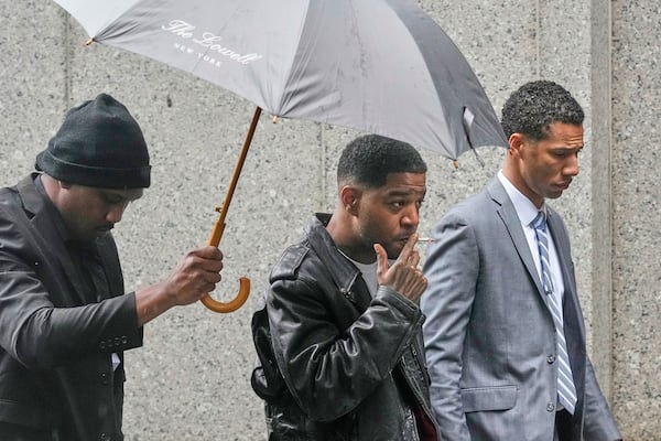 Rapper Kid Cudi, center, arrives at Federal Court for the trial of Sean "Diddy" Combs, in New York, Thursday, May 22, 2025. (AP Photo/Richard Drew)
