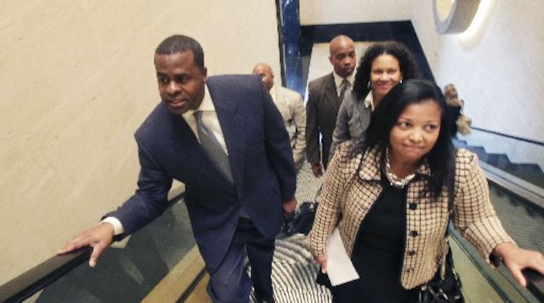 Atlanta City Attorney Cathy Hampton, seen here in a 2011 photo with Mayor Kasim Reed, will leave her position in late May, the city said Tuesday.