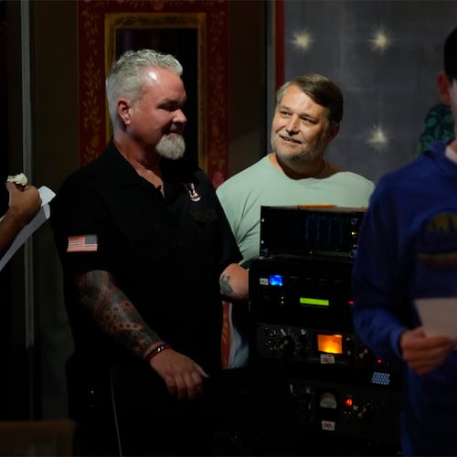 Army veterans David Booth, left, and Clay Jensen, center, watch as musicians and sound technicians prepare to record a song based on their military experiences on Wednesday, Sept. 9, 2025, in Nashville, Tenn. (AP Photo/Mark Humphrey)