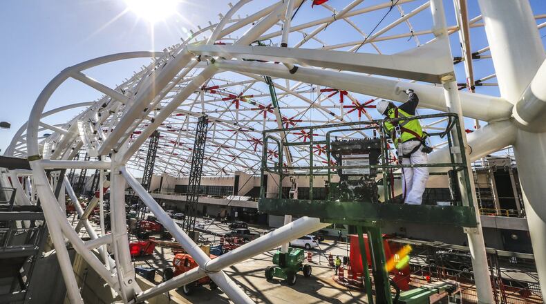 Construction work earlier this year on the canopy on the North side of Hartsfield-Jackson’s domestic terminal. JOHN SPINK/JSPINK@AJC.COM