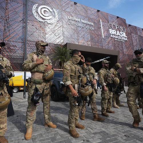Security personnel work outside an entrance to the COP30 U.N. Climate Summit, Wednesday, Nov. 19, 2025, in Belem, Brazil. (AP Photo/Andre Penner)
