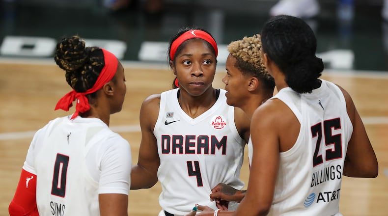 Dream players Odyssey Sims (from left), Aari McDonald , Courtney Williams, and Monique Billings huddle up against the Chicago Sky on Wednesday, May 19, 2021, in College Park. “Curtis Compton / Curtis.Compton@ajc.com”