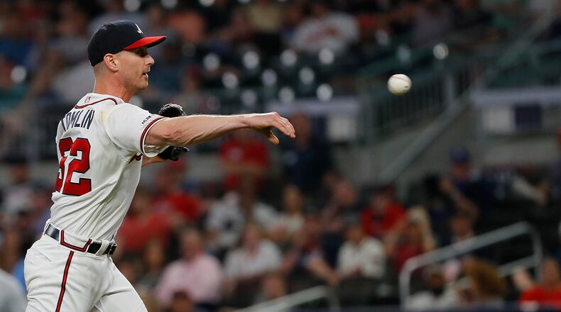 ATLANTA, GEORGIA - MAY 01:  Josh Tomlin #32 of the Atlanta Braves throws out Ian Kinsler #3 of the San Diego Padres at homeplate after scooping up a grounder hit by Franmil Reyes #32 in the eighth inning at SunTrust Park on May 01, 2019 in Atlanta, Georgia. (Photo by Kevin C. Cox/Getty Images)