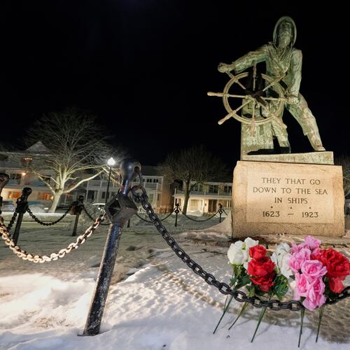 Flowers are seen placed at the Gloucester Fisherman's Memorial in Gloucester, Mass., after a fishing boat from port city went missing off the coast of Massachusetts with multiple people on board, Friday, Jan. 30, 2026. (AP Photo/Robert F. Bukaty)