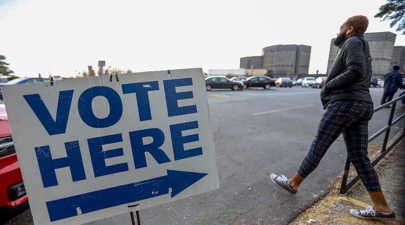 A person walks outside of the Voter Registration and Elections Office in Dekalb County during of the first day of early voting on Monday, March 2, 2020.