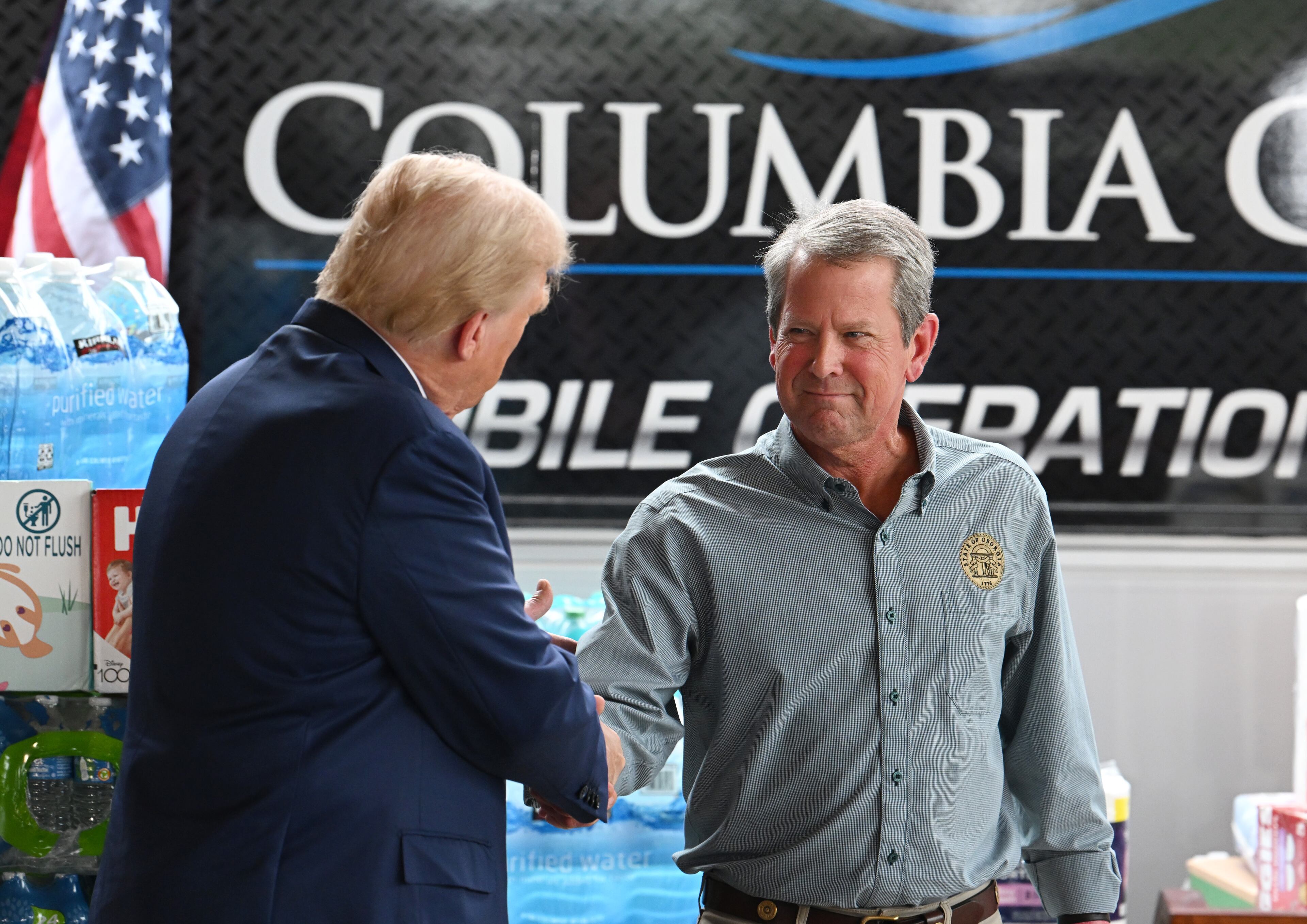 President Donald Trump greets with Gov. Brian Kemp during a press event while traveling to east Georgia to survey damage from Hurricane Helene, Friday, October 4, 2024, in Evans. Former President Donald Trump and Gov. Brian Kemp made their first appearance together since before the 2020 election, traveling to east Georgia to survey damage from Hurricane Helene. (Hyosub Shin / AJC)