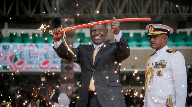 FILE - Kenya's new president William Ruto holds up a ceremonial sword as he is sworn in to office at a ceremony held at Kasarani stadium in Nairobi, Kenya Tuesday, Sept. 13, 2022. (AP Photo/Brian Inganga, File)