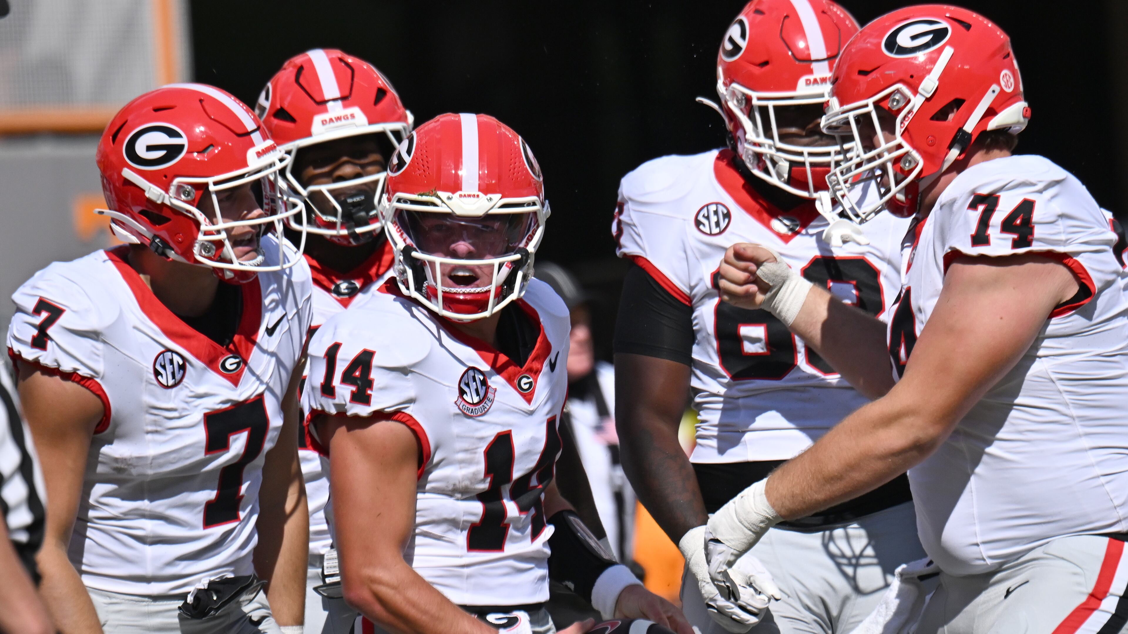 Georgia quarterback Gunner Stockton (center left) celebrates with teammates after scoring a touchdown during the first half at Neyland Stadium on Saturday, Sept. 13, 2025, in Knoxville, Tenn. (Hyosub Shin/AJC)