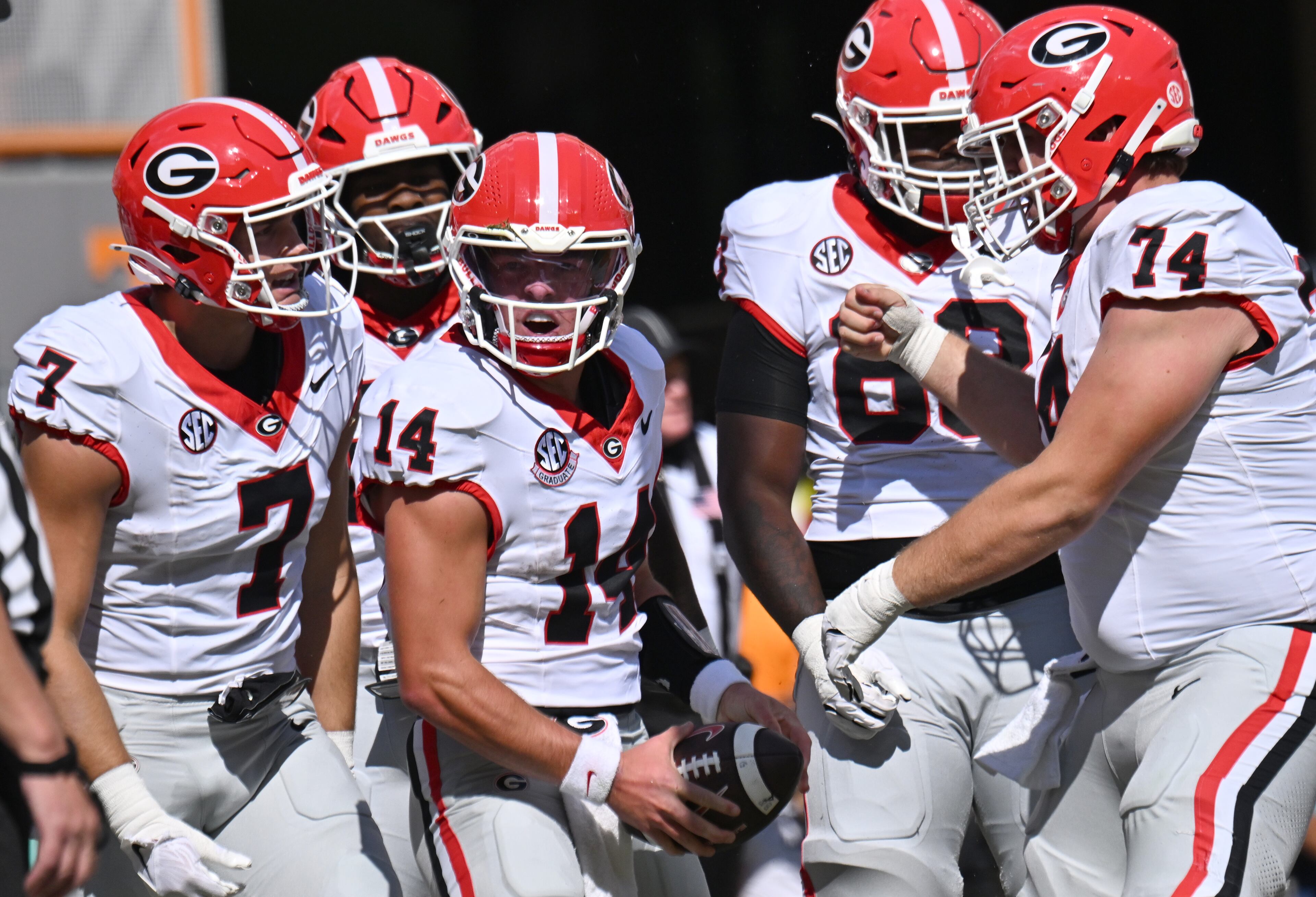Georgia quarterback Gunner Stockton (center left) celebrates with teammates after scoring a touchdown during the first half against Tennessee at Neyland Stadium on Saturday, Sept. 13, 2025, in Knoxville, Tenn. (Hyosub Shin/AJC)
