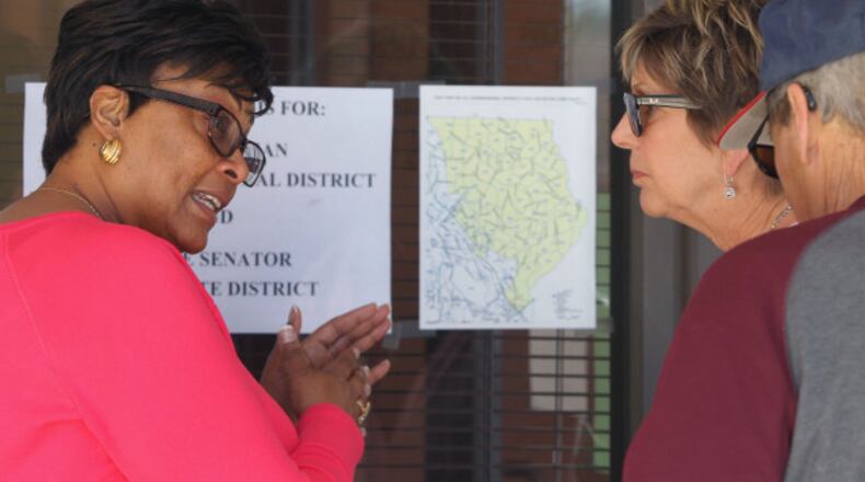April 10, 2017, Atlanta, Georgia - An election worker looks over the map of the 6th district with residents that arrived to vote at the Marietta Elections Main Office in Marietta, Georgia, on April 10, 2017. Officials said a number of people who were not eligible to vote in the election because they did not live in the district arrived on both Saturday and Monday. (HENRY TAYLOR / HENRY.TAYLOR@AJC.COM)