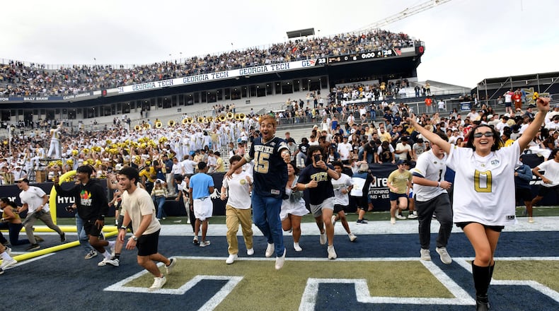 Georgia Tech fans storm the field after an NCAA college football game against Miami at Georgia Tech's Bobby Dodd Stadium, Saturday, November 9, 2024, in Atlanta. Georgia Tech won 28-23 over Miami. (Hyosub Shin / AJC)