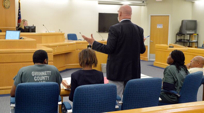 Defense attorney Jeff Sliz presents an argument as Recardo and Therian Wimbush appear before Gwinnett County Superior Court Judge Karen Beyers during a bond hearing Tuesday, August 5, 2014. The former Georgia Tech football star and his wife were denied bond. They are accused of locking their 13 year old son in the basement for months. KENT D. JOHNSON/KDJOHNSON@AJC.COM