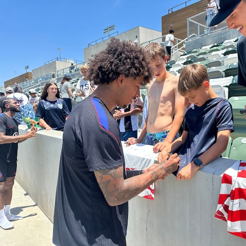 United States defender Chris Richards, front left, gives autographs to fans after the nationall team's first practice at its World Cup soccer tournament training base in Irvine, Calif., Monday, June 8, 2026. (AP Photo/Greg Beacham)