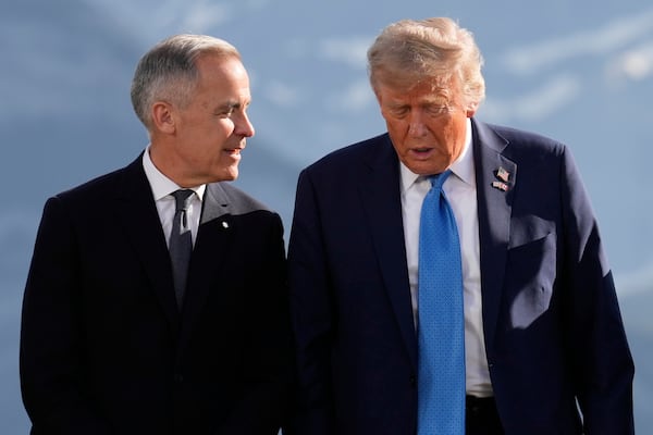 Canada's Prime Minister Mark Carney talks with President Donald Trump before a group photo at the G7 Summit, Monday, June 16, 2025, in Kananaskis, Canada. (AP Photo/Mark Schiefelbein)
