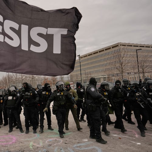 FILE - Federal immigration officers confront protesters outside Bishop Henry Whipple Federal Building, Jan. 15, 2026, in Minneapolis. (AP Photo/John Locher, File)