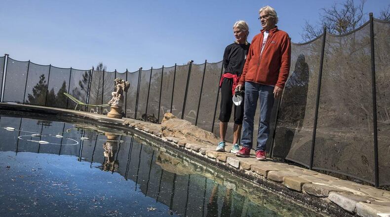 Jan and John Pascoe stand on the edge of the pool that saved their lives. The Santa Rosa, Calif., couple took refuge in their neighbor’s pool when a wind-driven wildfire engulfed their neighborhood last week in a matter of minutes.