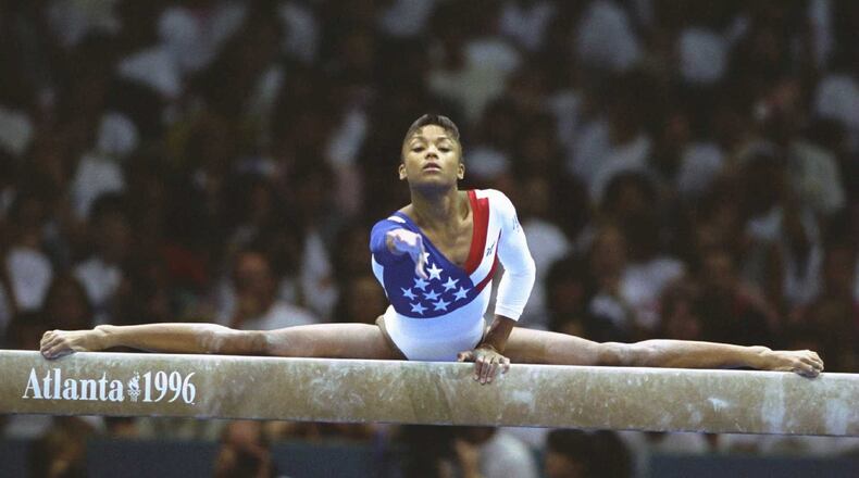 American gymnast Dominique Dawes performs on the balance beam during the women's team gymnastics event Tuesday, July 23, 1996, during the Summer Games at the Georgia Dome in Atlanta. (Doug Pensinger/Allsport)