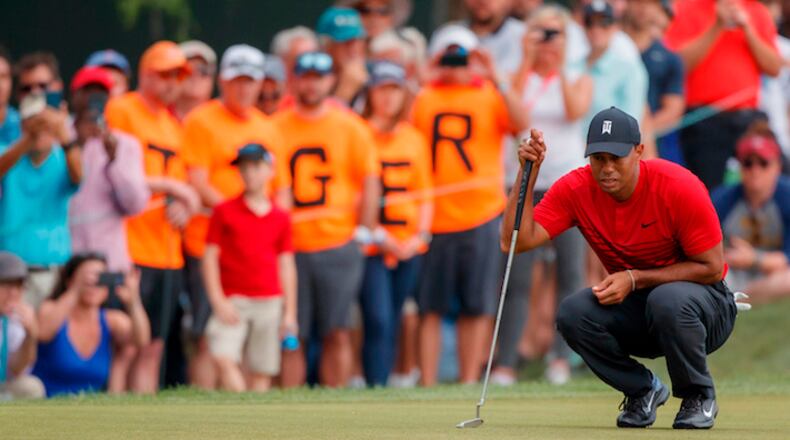 In this March 11, 2018, file photo, Tiger Woods lines up a putt on the 13th hole during the final round of the Valspar Championship golf tournament, in Palm Harbor, Fla. The buzz following Woods since his return from a fourth back surgery has been bigger and louder than when he was No. 1 in the world, piling up 79 victories on the PGA Tour and 14 majors. (AP Photo/Mike Carlson, File)
