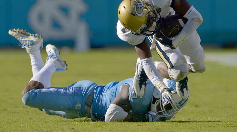 Donnie Miles #15 of the North Carolina Tar Heels trips up Qua Searcy #1 of the Georgia Tech Yellow Jackets during the game at Kenan Stadium on November 5, 2016 in Chapel Hill, North Carolina. North Carolina won 48-20. (Photo by Grant Halverson/Getty Images)