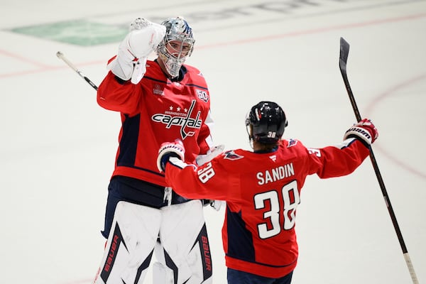 Washington Capitals goaltender Logan Thompson, left, celebrates with defenseman Rasmus Sandin (38) after Game 2 of a first-round NHL hockey playoff series against the Montreal Canadiens Wednesday, April 23, 2025, in Washington. (AP Photo/Nick Wass)