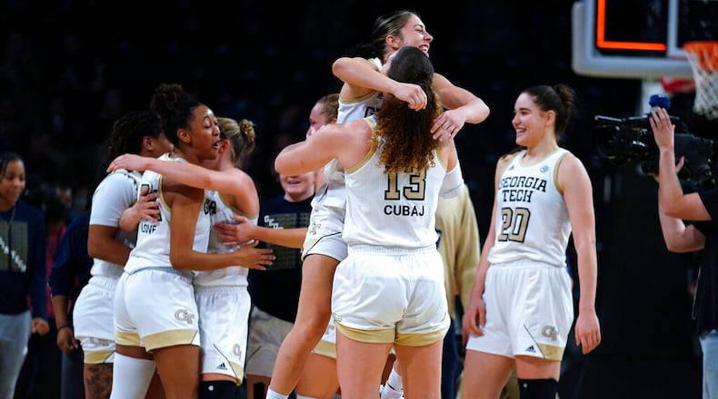 Georgia Tech's Sarah Bates (3) and Lorela Cubaj (13) celebrate after Georgia Tech defeated Connecticut in an NCAA college basketball game Thursday, Dec. 9, 2021, in Atlanta. (AP Photo/John Bazemore)