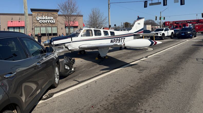 This image provided by Gainesville Police Department shows a small plane that made an emergency landing on a street in Gainesville, Ga., Monday, Feb. 9, 2026. (Gainesville, Ga., Police Department via AP)
