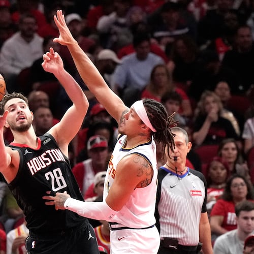 Houston Rockets center Alperen Sengun (28) passes the ball against Denver Nuggets forward Aaron Gordon during the first half of an NBA Cup basketball game, Friday, Nov. 21, 2025, in Houston. (AP Photo/Karen Warren)