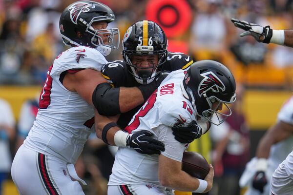 Falcons quarterback Cooper Rush (right) gets sacked by Steelers linebacker Alex Highsmith. (Gene J. Puskar/AP)