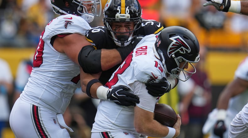 Falcons quarterback Cooper Rush (13) is sacked by Pittsburgh Steelers linebacker Alex Highsmith (56) during an NFL football game Sunday, Sept. 13, 2026, in Pittsburgh. (AP Photo/Gene J. Puskar)