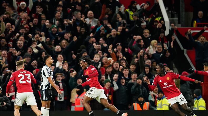 Manchester United's Patrick Dorgu, center, celebrates after scoring the opening goal during the English Premier League soccer match between Manchester United and Newcastle in Manchester, England, Friday, Dec. 26, 2025. (AP Photo/Dave Thompson)