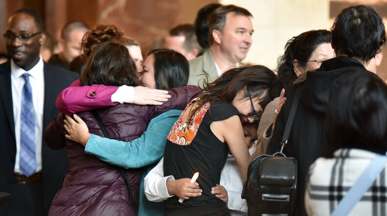 Loved ones gather for a candlelight vigil for Trinh Huynh at the lobby of the 999 Building in Midtown Atlanta on Thursday, April 6, 2017. Huynh was shot Monday morning as she walked in Midtown. HYOSUB SHIN / HSHIN@AJC.COM