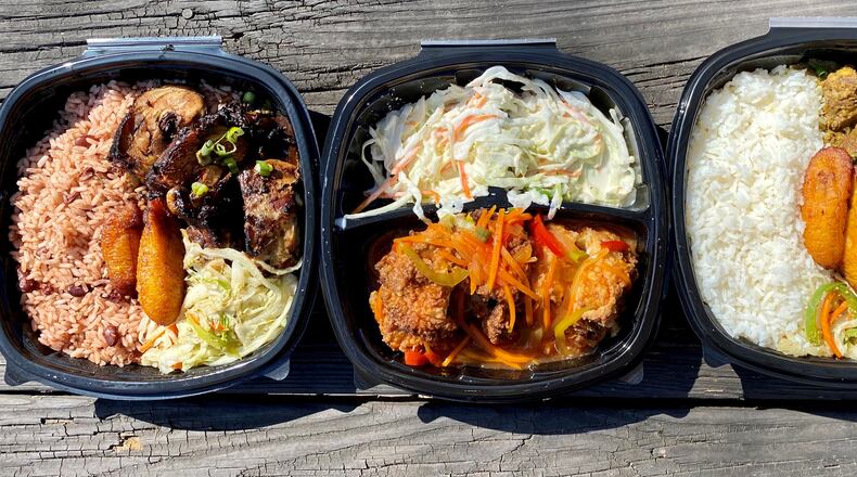 A takeout feast from Spicy Hill includes jerk chicken, fried chicken and curry goat. Wendell Brock for The Atlanta Journal-Constitution
