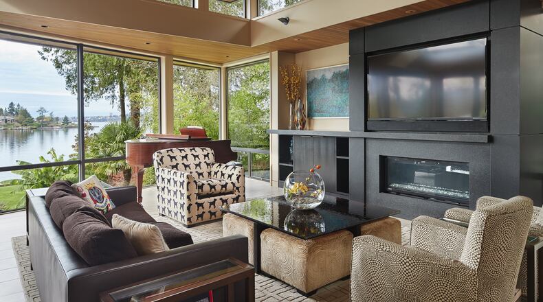 The great room “got a lot of attention,” architect Brian Brand says. “The family spends a lot of time together. They don’t do formal living; this works on a day-to-day basis.” Midcentury-modern elements (“restful horizontal lines, fitting into the environment, light from above and multiple-height ceilings”) blend with wood ceilings, a nod to Northwest modern architecture, he says; the ceilings here are high “because of all the light and art.” (Benjamin Benschneider/Seattle Times/TNS)