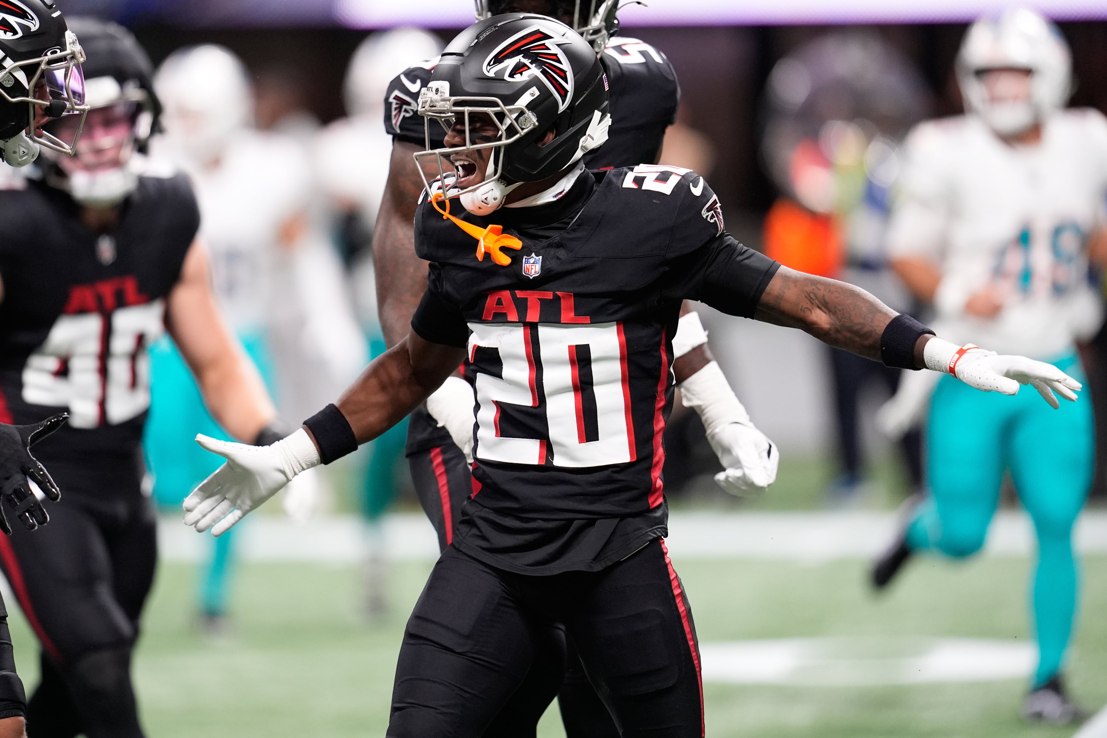 Falcons cornerback Dee Alford celebrates his sack of Dolphins quarterback Tua Tagovailoa.