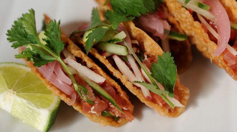 Ahi Tacos- crispy taco shell, fresh tuna, crunchy vegetables and spicy avocado aioli.