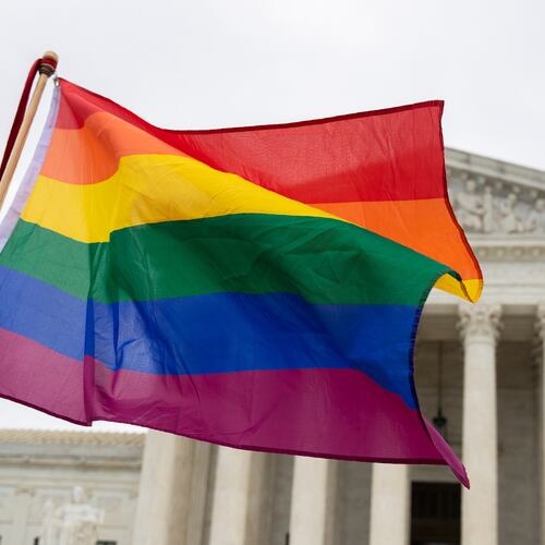 FILE - Supporters of the LGBT wave their flag in front of the U.S. Supreme Cour, Oct. 8, 2019, in Washington. (AP Photo/Manuel Balce Ceneta, File)