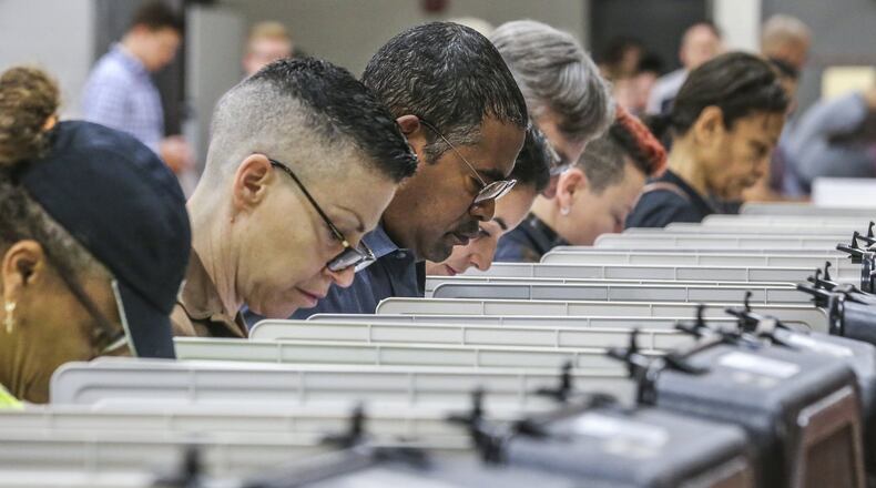 Voters lined up early at Henry W. Grady High School in Atlanta on Nov. 7 to cast their votes in Atlanta’s mayoral race. JOHN SPINK/JSPINK@AJC.COM