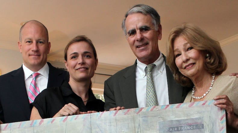 Wright Mitchell (left to right), Katherine McClure, Frank Virgin and Penny Hart hold a painting by McClure.