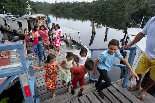 Children arrive at the Emilio Goeldi Museum's scientific station in the Caxiuana National Forest in Para state, Brazil, Friday, March 21, 2025. (AP Photo/Jorge Saenz)