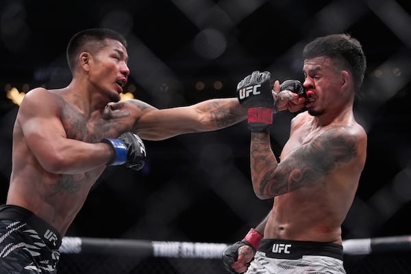 Joshua Van hits Brandon Royval in a flyweight fight at UFC 317, Saturday, June 28, 2025, in Las Vegas. (AP Photo/John Locher)