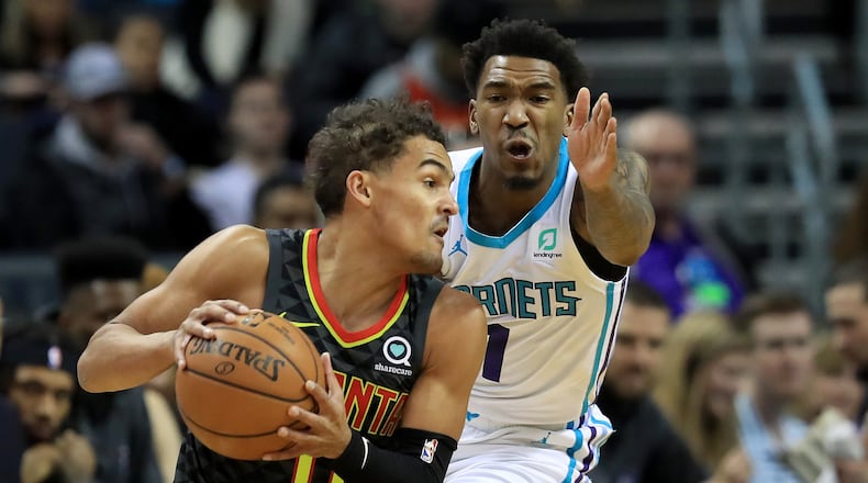 Malik Monk of the Charlotte Hornets tries to stop Trae Young #11 of the Atlanta Hawks during their game at Spectrum Center on December 08, 2019 in Charlotte, North Carolina.
