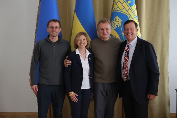 (From left to right) Serhiy Kiral, former head of the Department for International Economy and Investments in the Lviv City Council; Olga Gorman, CEO of HelpingUkraine; Lviv Mayor Andriy Sadovyi and Emory Morsberger, founder of HelpingUkraine in Ukraine in June 2025. (Courtesy of Roman Baluk)