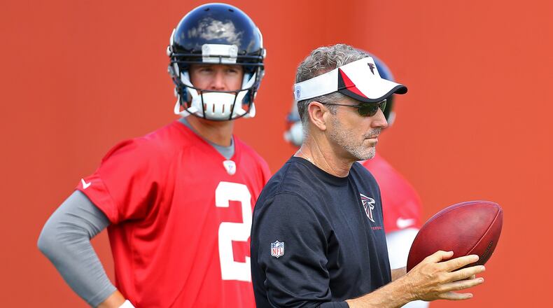Falcons offensive coordinator Dirk Koetter works with Matt Ryan during team practice on Tuesday, June 10, 2014, in Flowery Branch.