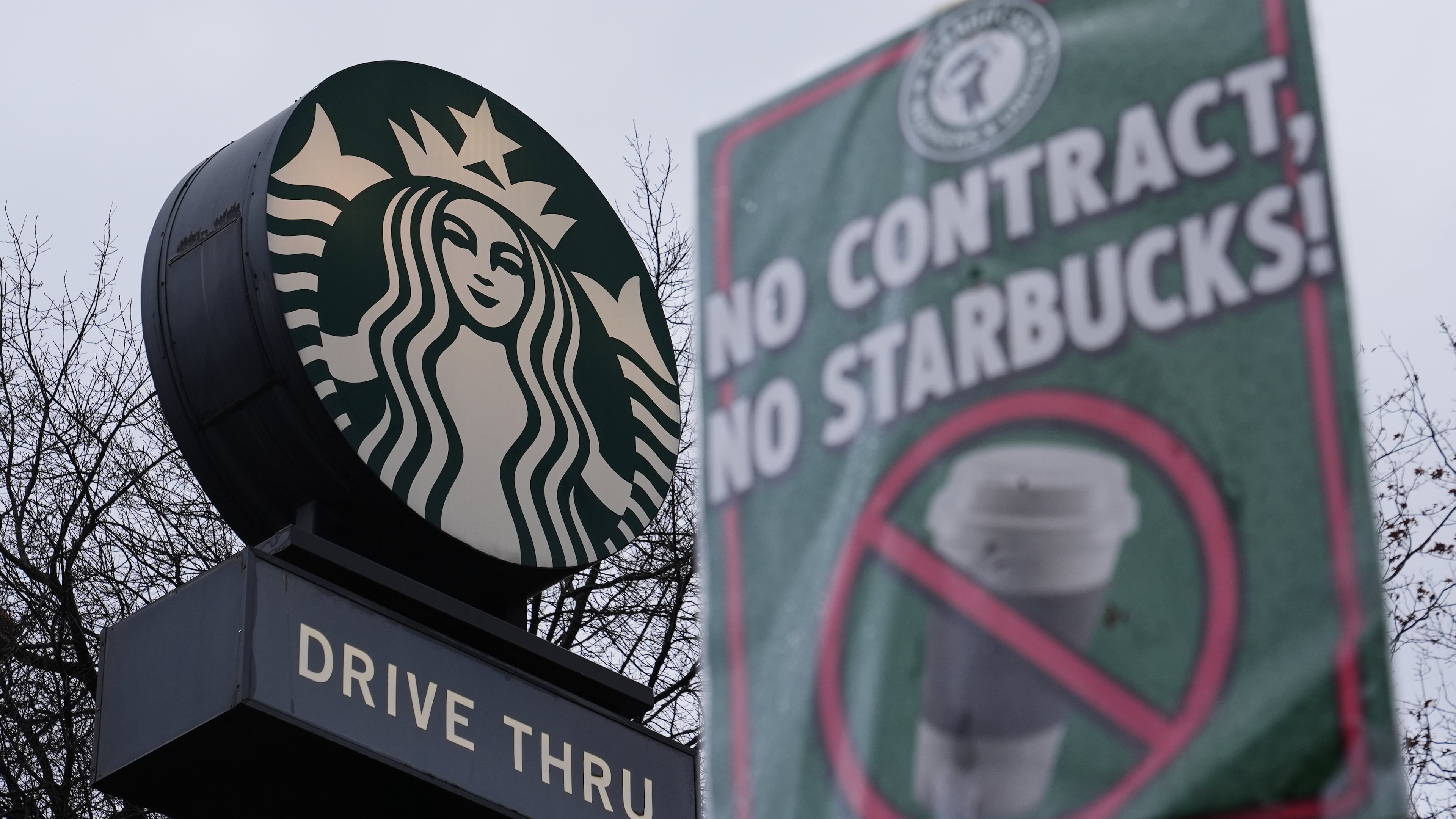 The Starbucks logo is seen as workers strike outside a store Thursday, Nov. 13, 2025, in Seattle. (AP Photo/Lindsey Wasson)